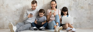 Family using digital devices together, highlighting online connectivity.